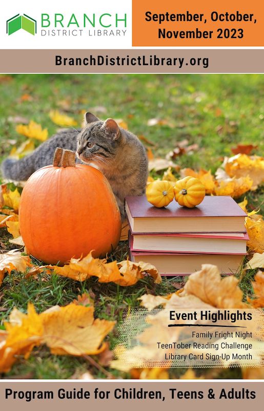 Fall scene with a cat, pumpkin, and a stack of books. 