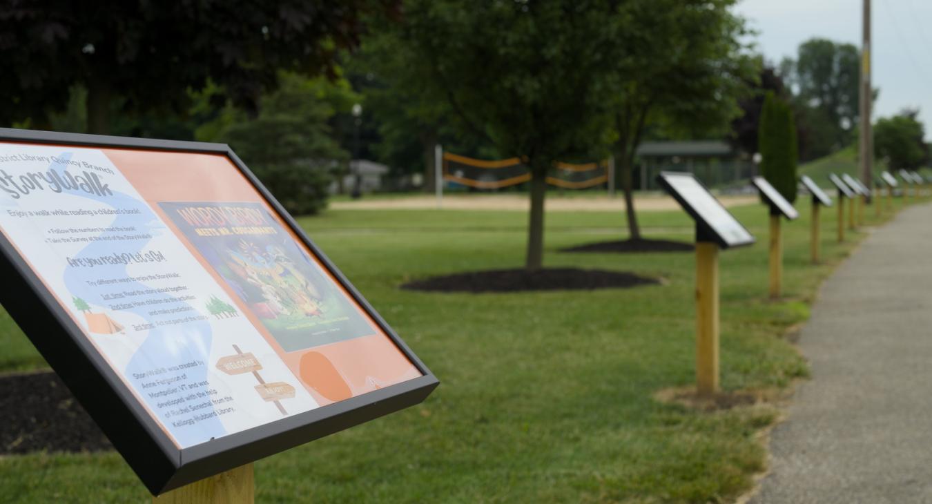 grass and sidewalk with signposts